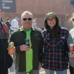 Greg-Tawney-Jack-Leek-Kelly-Hamrick-Kelly-Leek - Carroll News | Carroll Publications | Carroll County, MD Four adults standing together outdoors at a community event, each holding a drink and smiling.