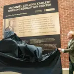 mcdaniel-college-kahlert - Carroll News | Carroll Publications | Carroll County, MD Two people unveil a plaque for the McDaniel College Kahler Nursing Education Center against a brick wall outside a hospital setting.