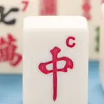 Mahjong Mania - Carroll News | Carroll Publications | Carroll County, MD Close-up of white Mahjong tiles, with the red 'ä¸' tile centered and other tiles showing Chinese characters in the background.
