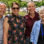 Scott-Wanda-Lynn-Jack-Beth-Tevis - Carroll News | Carroll Publications | Carroll County, MD Four adults smiling and posing outdoors at a park event, standing side by side (two men on sides, two women in the middle).